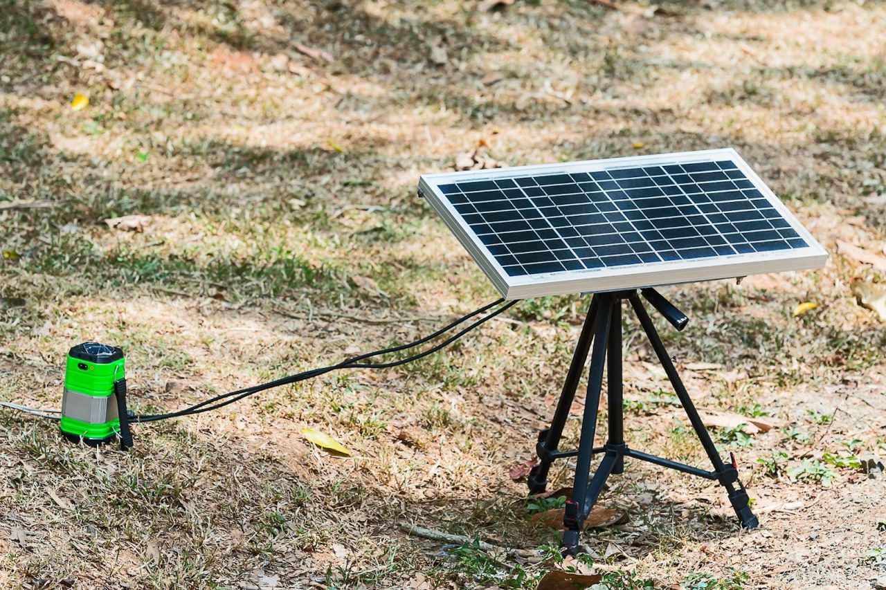 Small portable solar stand in field with battery. 
